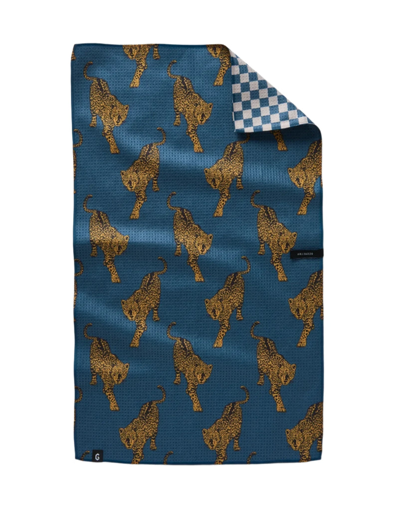 Unique and trendy tea towel with a reversible design, combining a bold leopard print and blue checkered print design on the reverse side. 