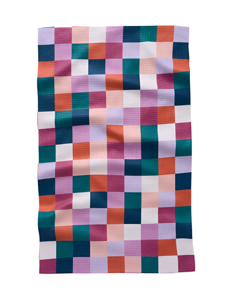 Brightly colored absorbent tea towel featuring a vibrant checkered print in jewel tones. Perfect for adding a pop of color to your kitchen while offering superior drying power and durability.