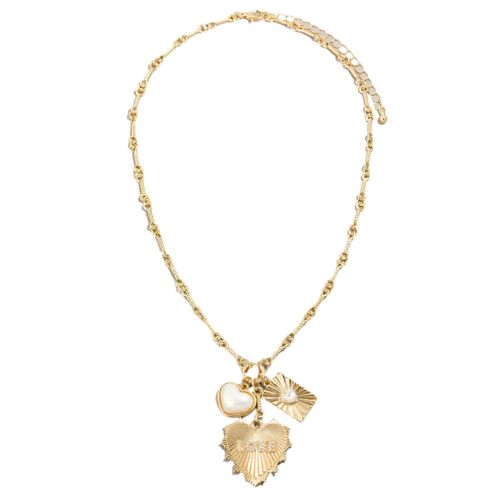 This Gold Multi-Charm Heart & Pearl Pendant Necklace is an Elegant Gold Chain with Textured Heart, Mother-of-Pearl, and Sunburst Pearl Charms. Chic & Timeless Statement Jewelry for Layering & Everyday Elegance.