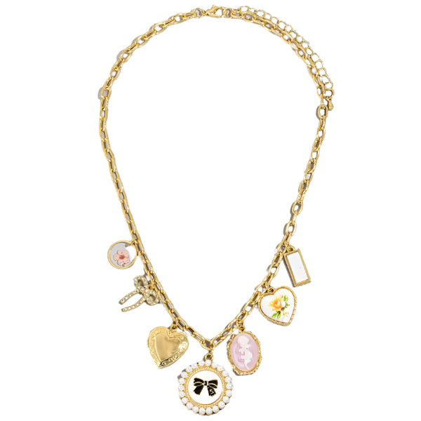 Charm necklace, featured on a classic, chunky gold chain with fun bow and heart variation charms spaced on it. Great gift idea and very popular jewelry choice. 